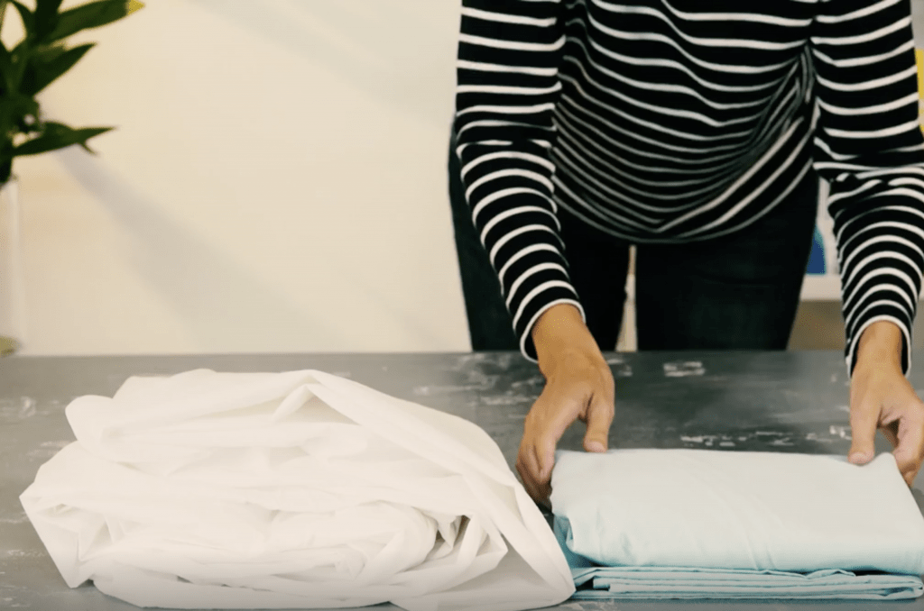 Folding fitted sheets is so easy with this simple trick!